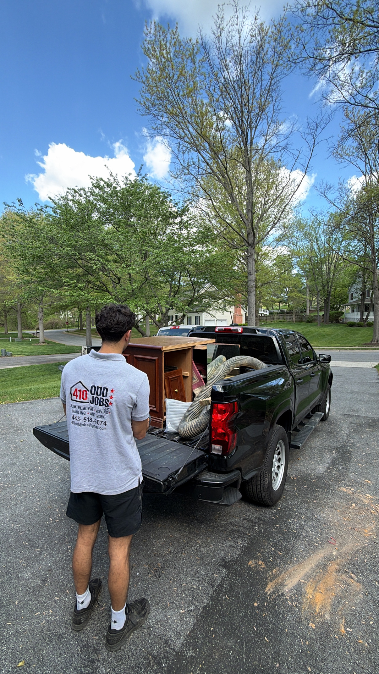410 Odd Jobs team member loading furniture into the truck