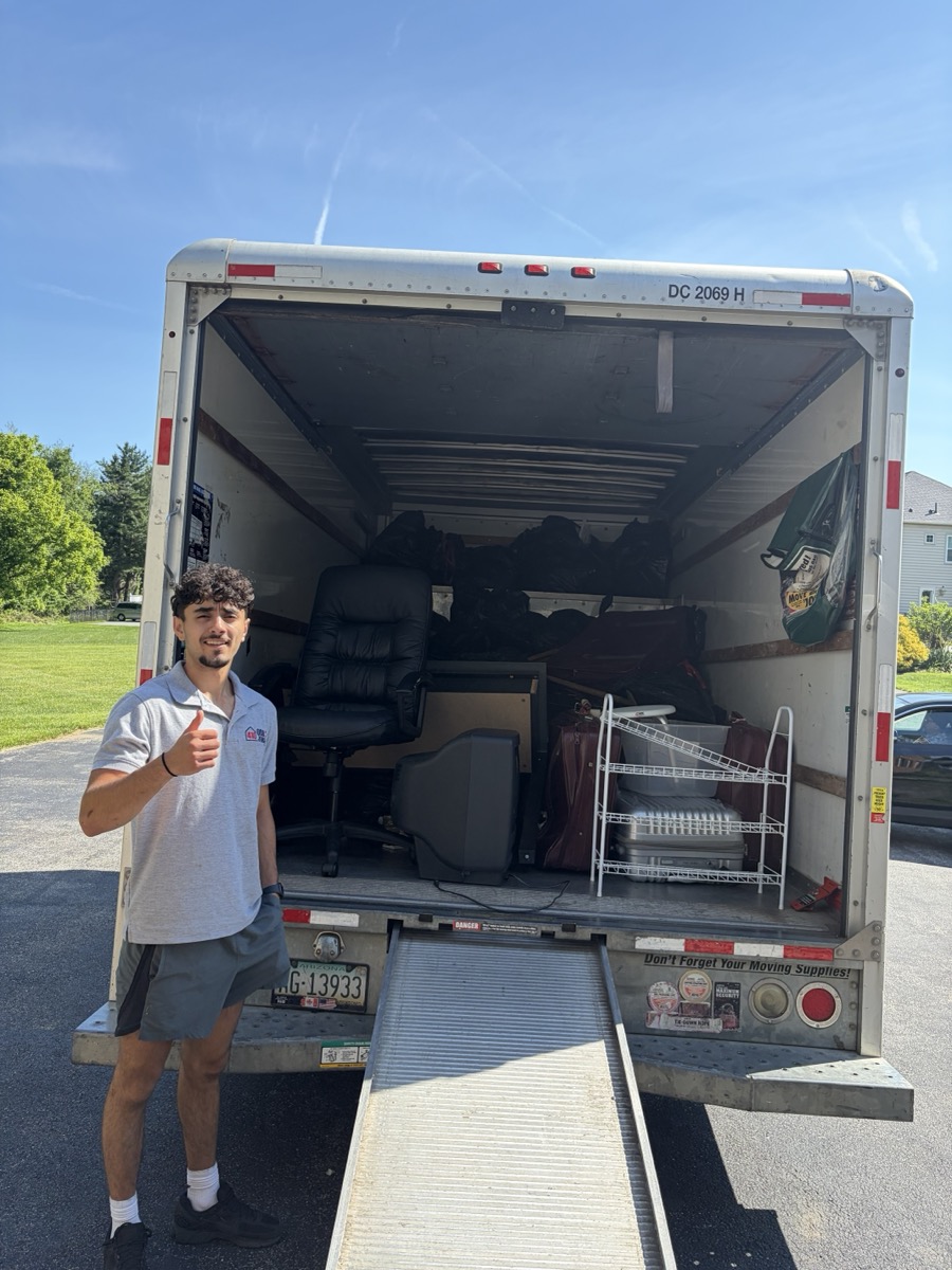 Ahmad in front of a loaded box truck