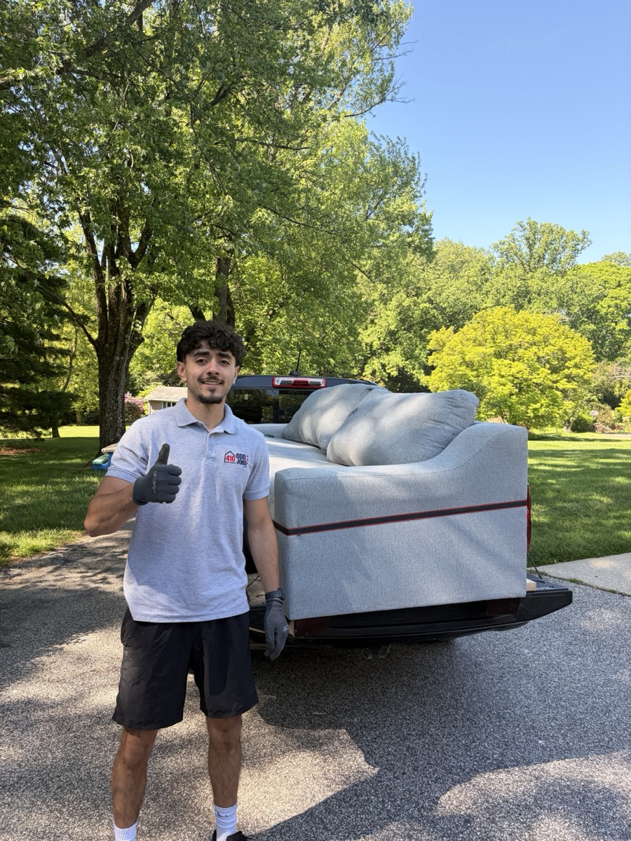 Ahmad with a couch loaded on a pickup truck
